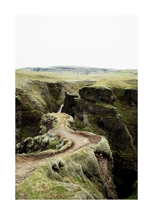 - Fotografi af en smal sti i et grønt landskab på Island