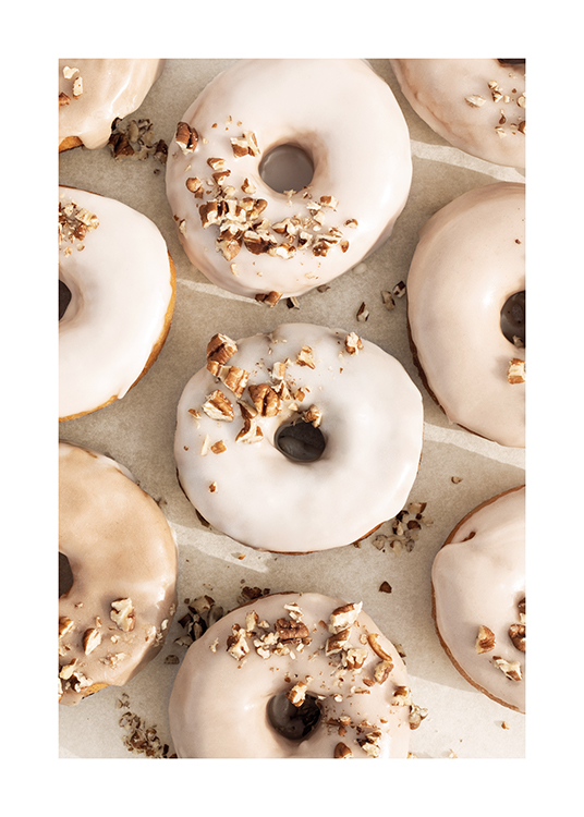 – Fotografi af doughnuts med beige og hvid glasur og hakkede nødder